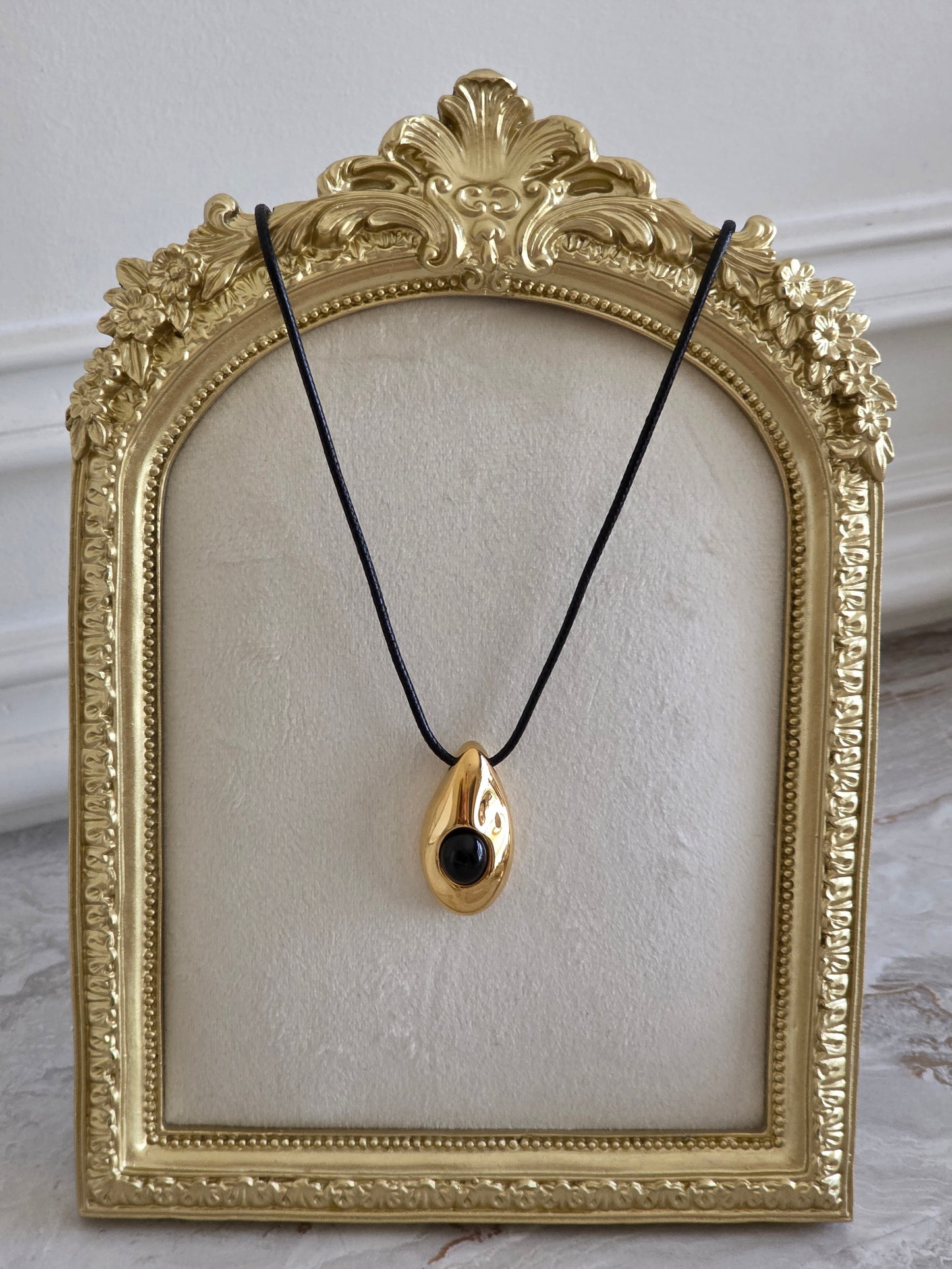 long black cord necklace with gold pendant