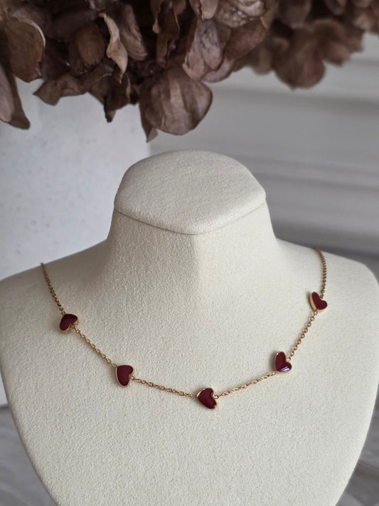gold necklace with red enamel hearts