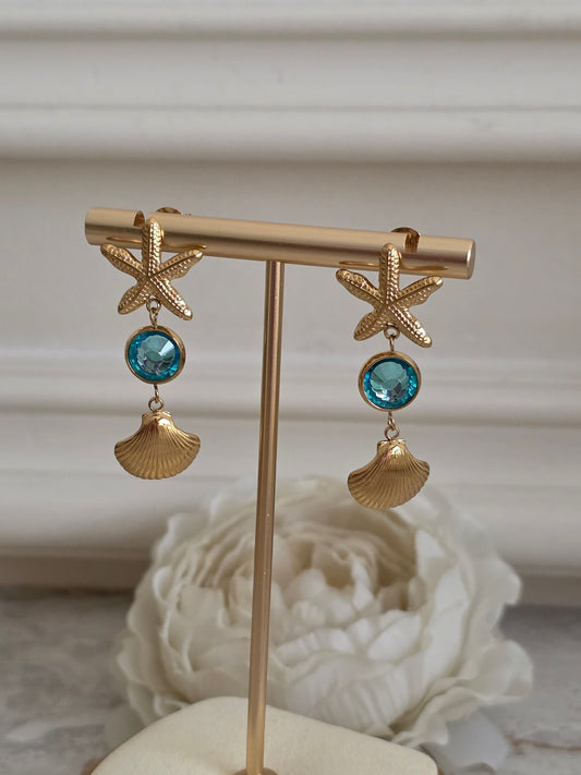 Sea shell dangling earrings with blue crystal