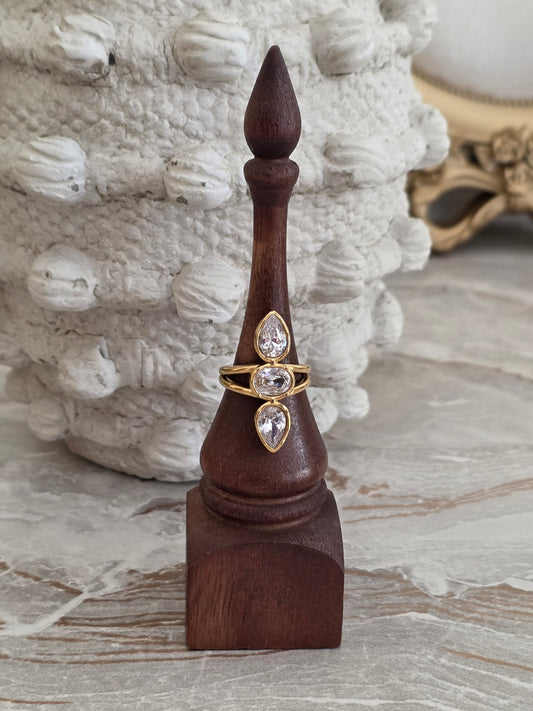 Mine Ring featuring three sparkling clear pear and oval-cut stones in a polished gold-tone adjustable band.
