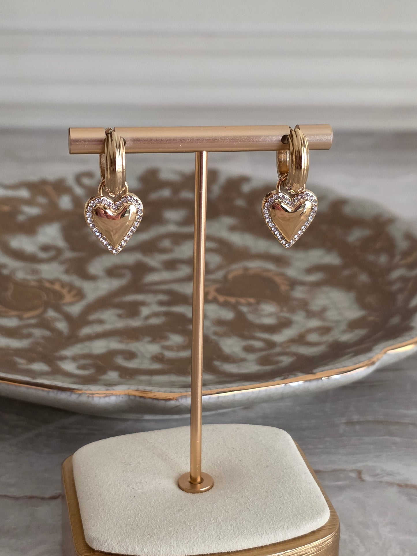 Gold hoop earrings with heart charm