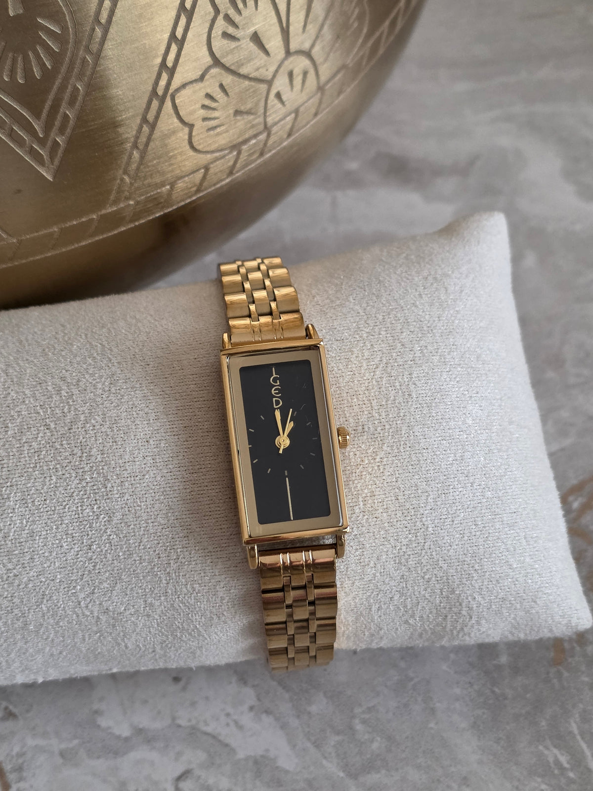 Gold Fay Watch with a slim rectangular black dial and polished gold-tone stainless steel bracelet band.