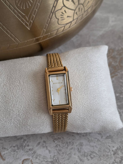Gold Layan Watch featuring a rectangular champagne-toned dial, slim woven stainless steel gold-plated band and adjustable wrist fit.