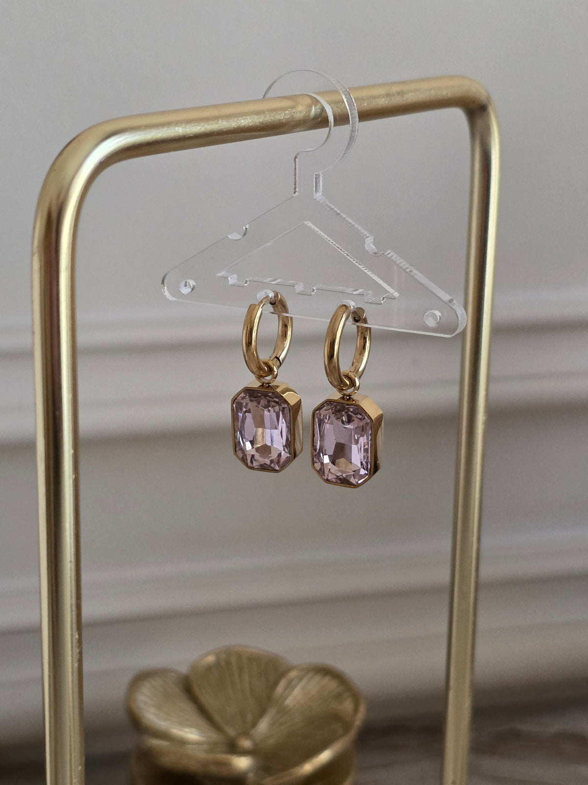 Nira Pink Hoop Earrings featuring gold hoops with faceted blush pink glass drop stones.