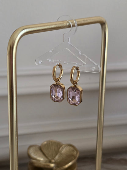 Nira Pink Hoop Earrings featuring gold hoops with faceted blush pink glass drop stones.