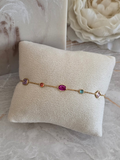 Reya Bracelet with delicate gold-toned chain and colourful multi-shaped jewel-inspired stones in pink, purple, blue and orange.