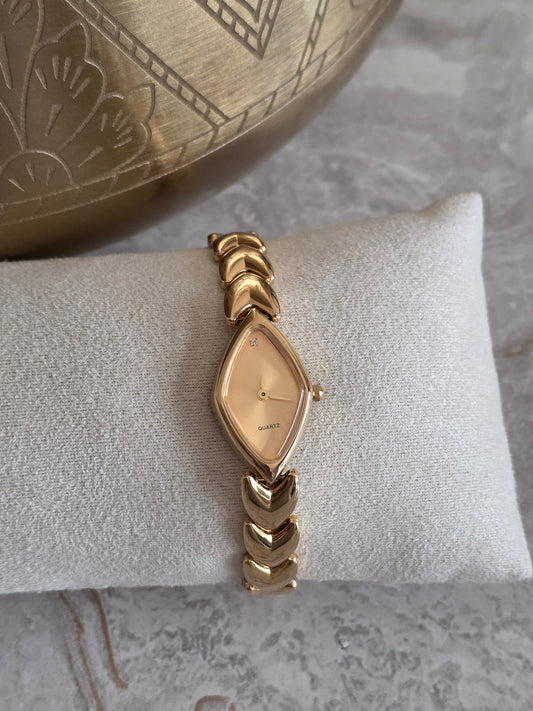 Gold Yasmina Watch featuring a unique marquise-shaped champagne dial, delicate crystal detail and polished gold-tone stainless steel bracelet band.