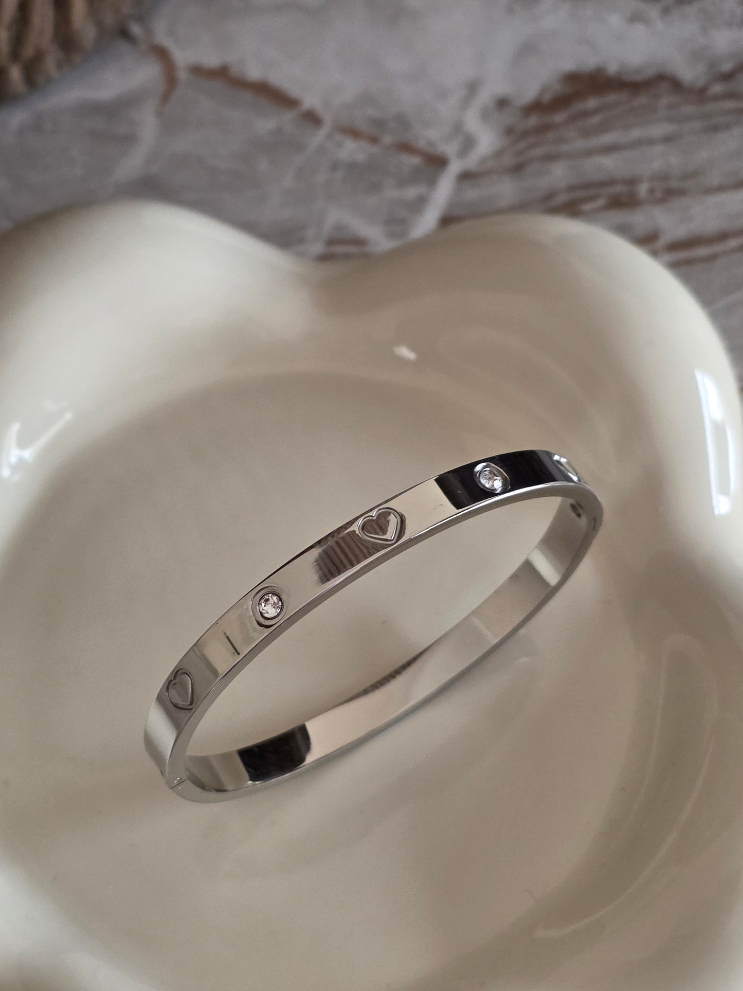 Silver bangke with heart detail and cubic zirconia 