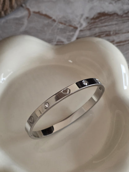 Silver bangke with heart detail and cubic zirconia 