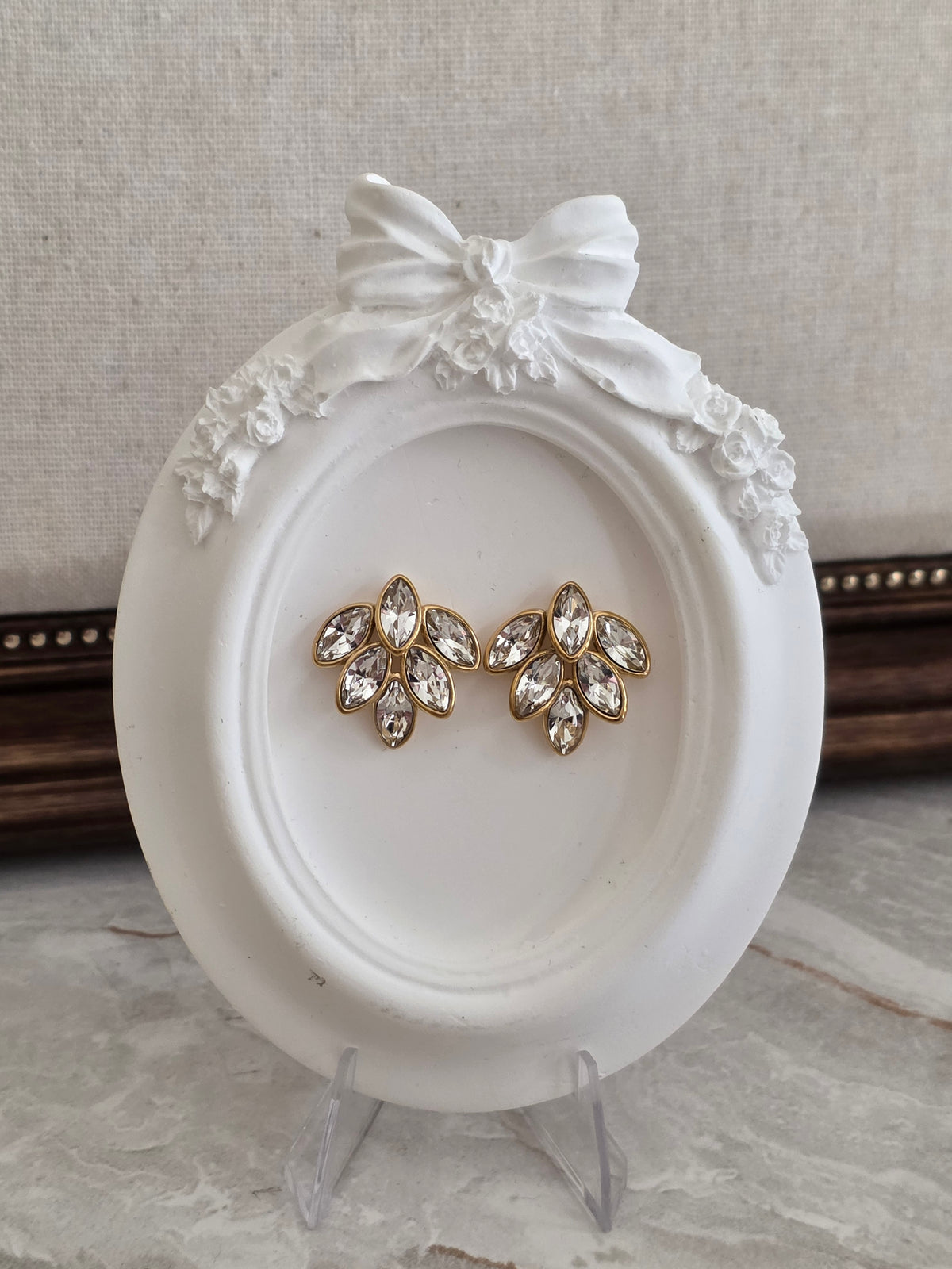 Bella Earrings featuring sparkling marquise-cut clear crystals in an elegant floral design with a polished gold-tone setting.