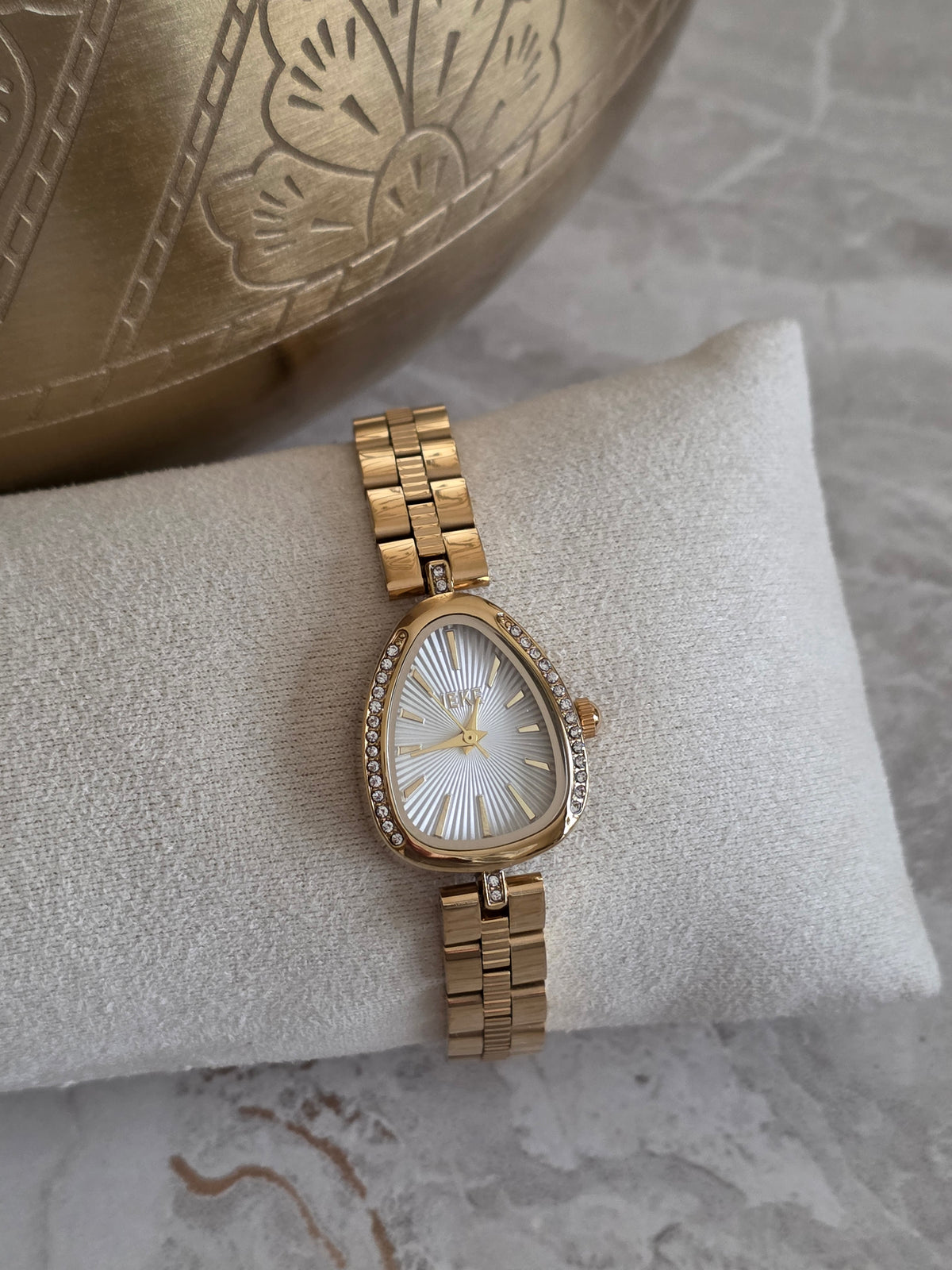 Gold Zera Watch featuring a teardrop-shaped silver dial, crystal detailing and a slim gold-tone stainless steel bracelet band.