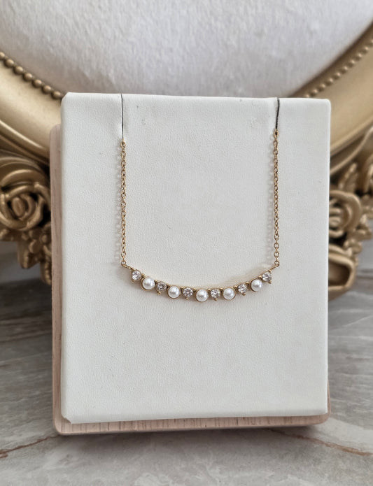 Ferda Pearl Necklace featuring pearl-inspired accents and sparkling crystal stones on a delicate gold chain.