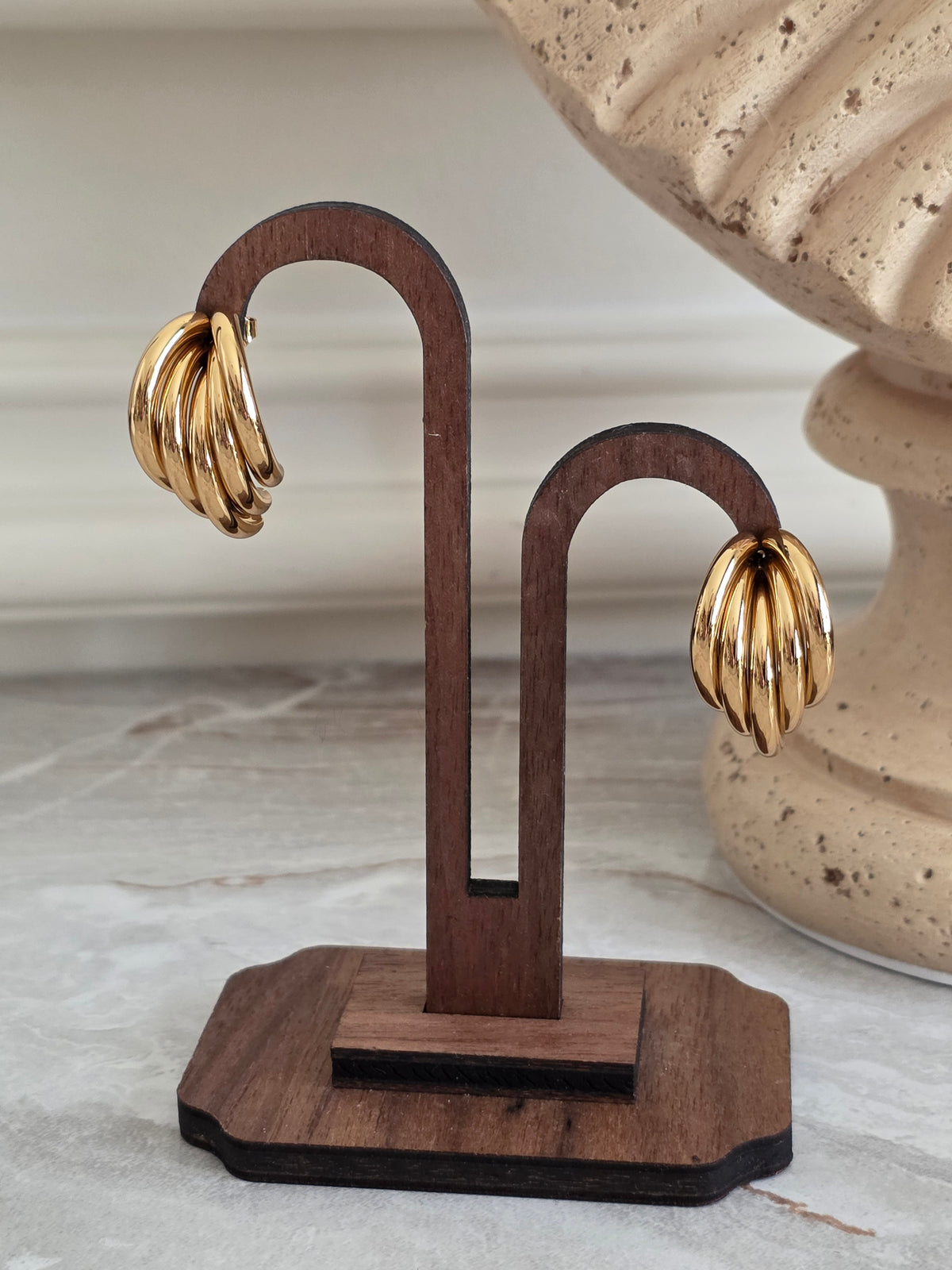 Gold Tazmina Earrings featuring a sculpted multi-ridged hoop design with a polished high-shine finish.