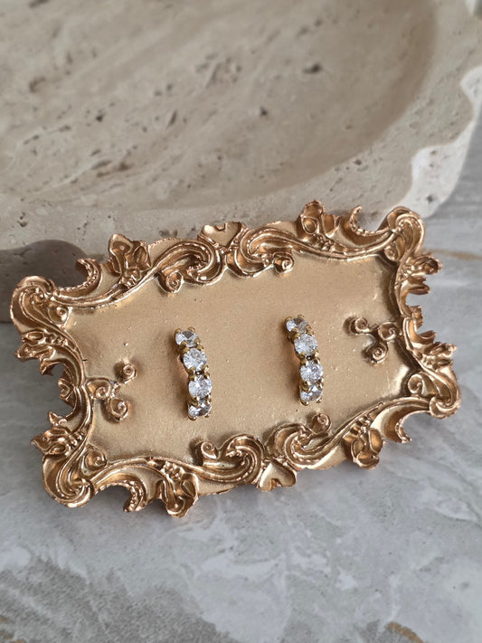 Gold row of 4 cubic zirconia earrings