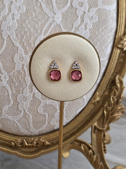 Sonia Pink Earrings featuring faceted blush-pink glass stones in gold-tone settings with sparkling clear crystal accents.