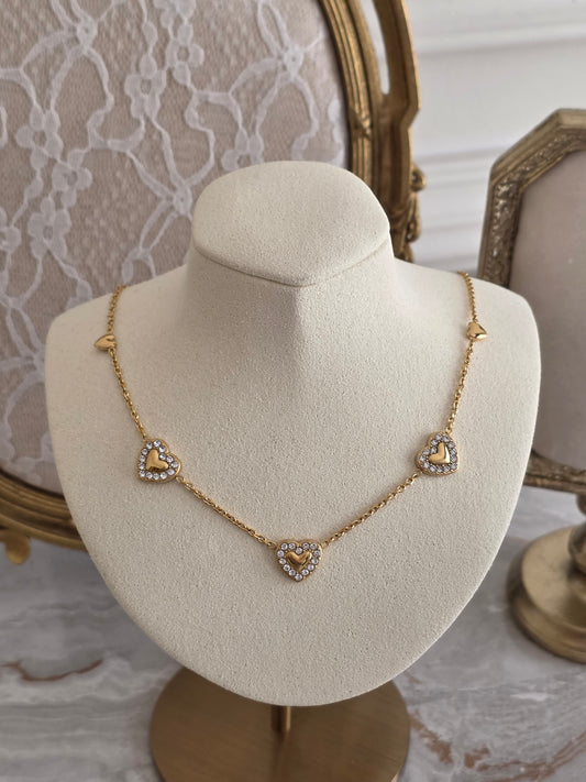 Gold heart necklace with 5 hearts and cubic zirconia detail
