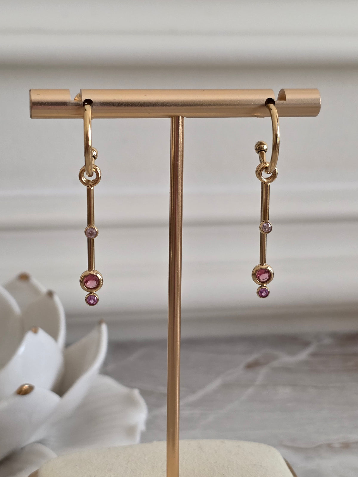 Aliyna gold drop earrings with delicate hoop design and pink and blush-toned stone accents.